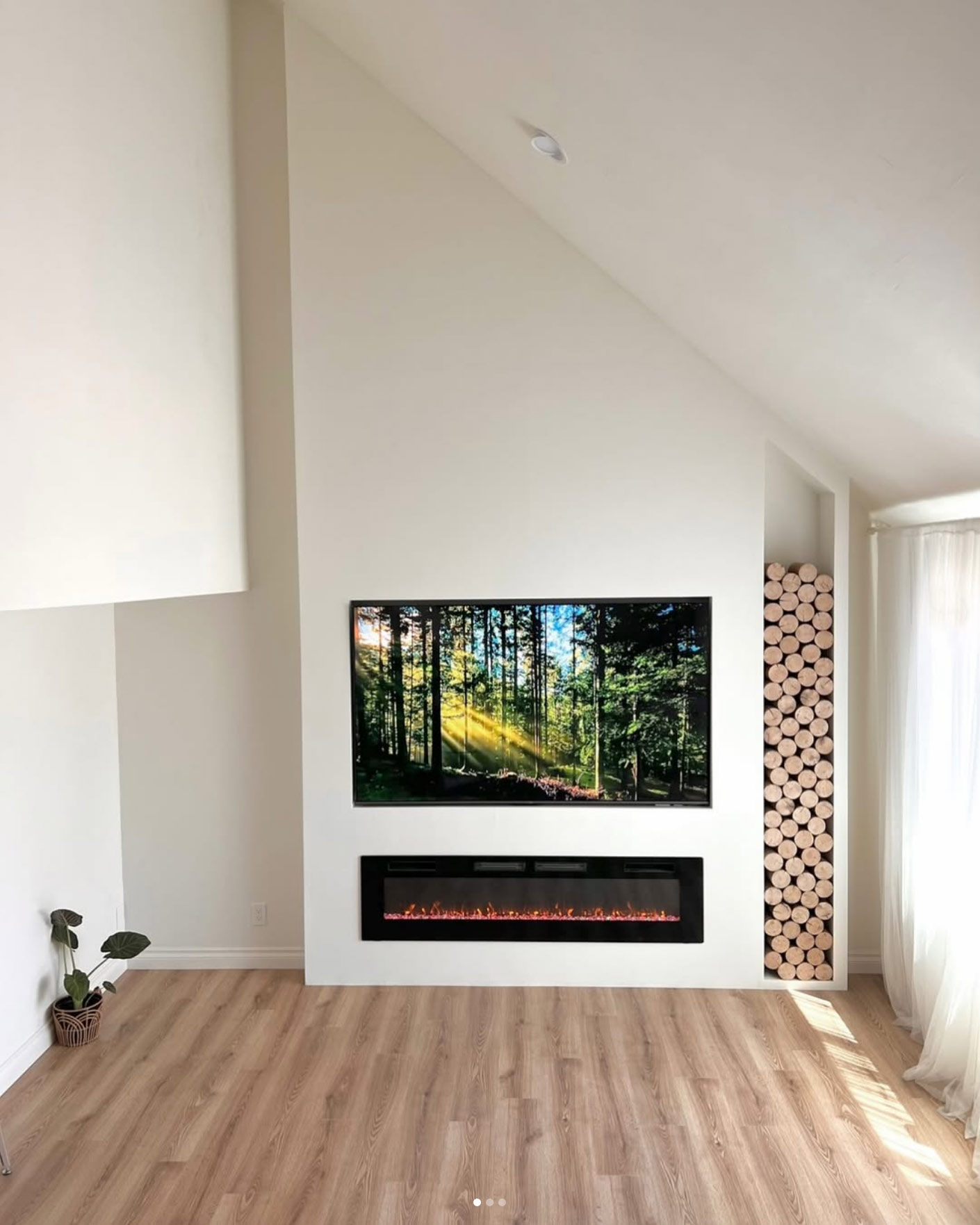 Fireplace remodeling by OK construction and remodeling featuring renovated electrical fireplace, flooring, and TV set on the wall