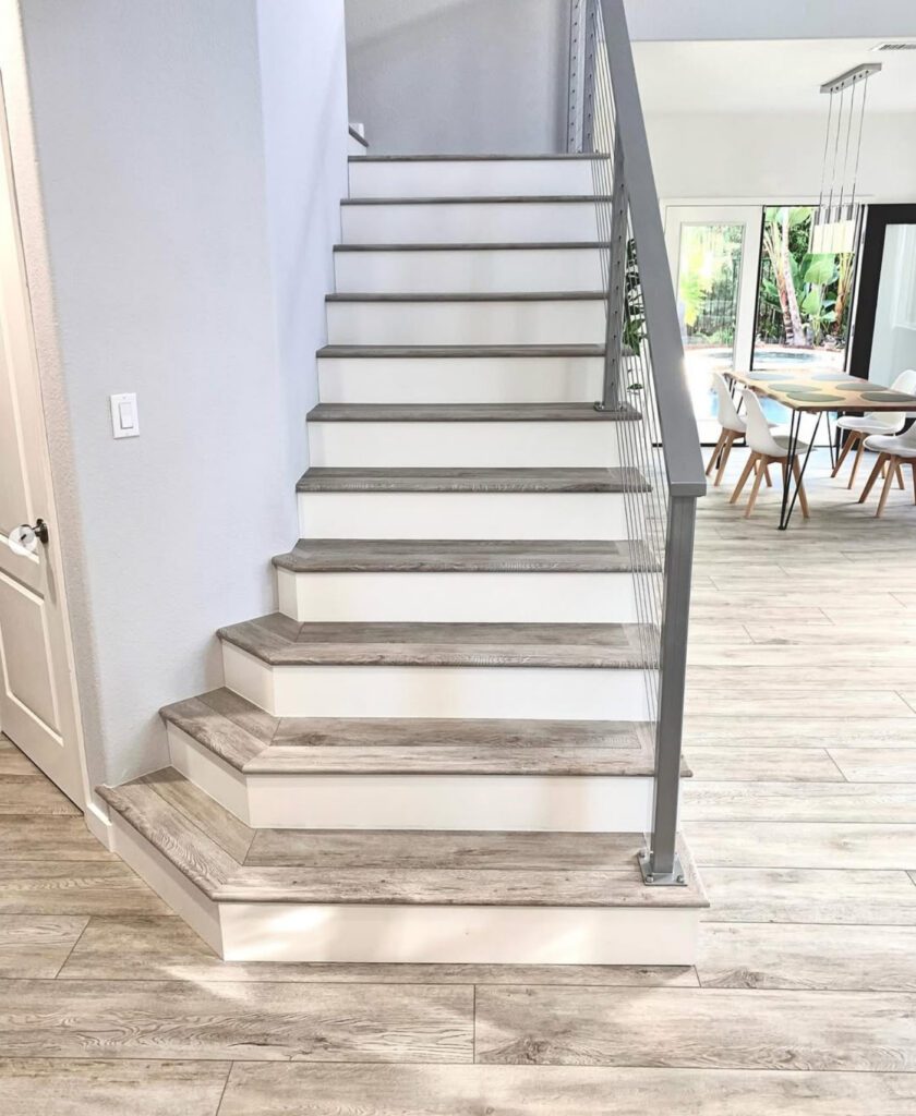 renovated stare case with light hard wood-look floor panels