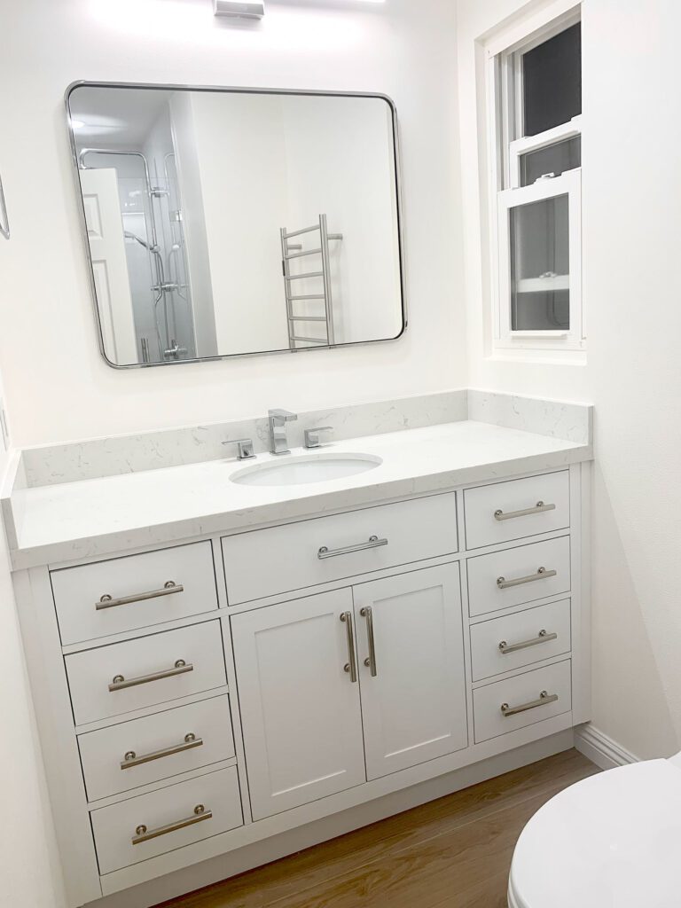 white finish bathroom, sink, mirror, and with cabinets