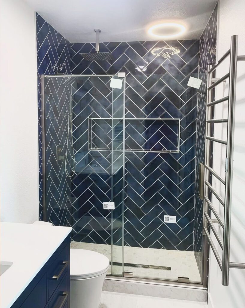 bathroom remodeling by Oleg Kuznetcov Construction and Remodeling. Dark blue tiles inside shower.
