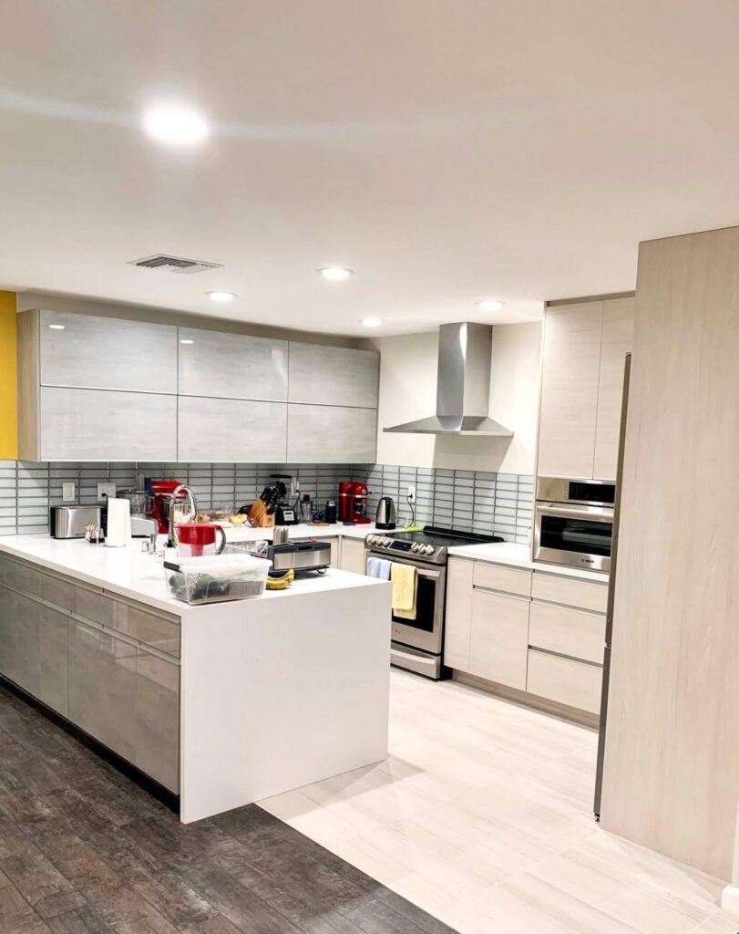 modern style kitchen remodeling featuring white counter top, cabinets, and light blue wall tiles