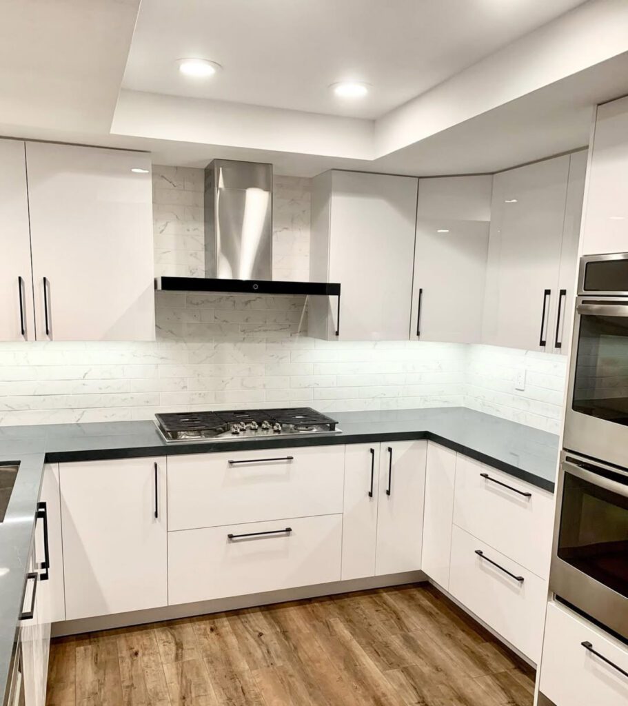 kitchen remodeling by OK construction and remodeling featuring very light kitchen with white cabinets and dark counter top