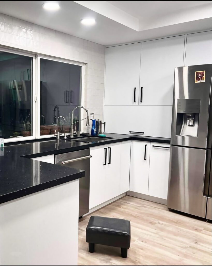 kitchen remodeling featuring white cabinets and black counter top