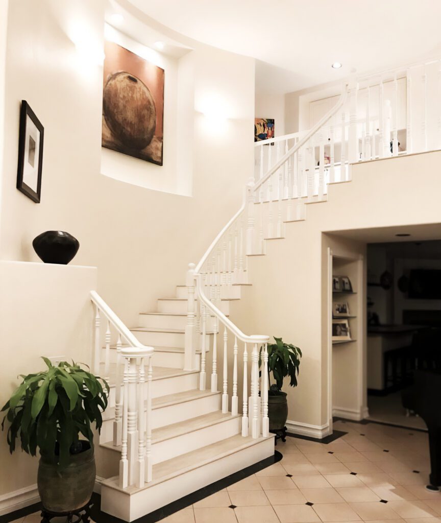 light staircase with white poles and rails