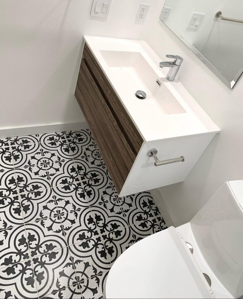 bathroom floor decorative tiles, and a sink